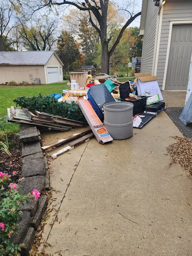 Dumpster being loaded with debris for Estate Cleanout Dumpster Rental in Vero Beach